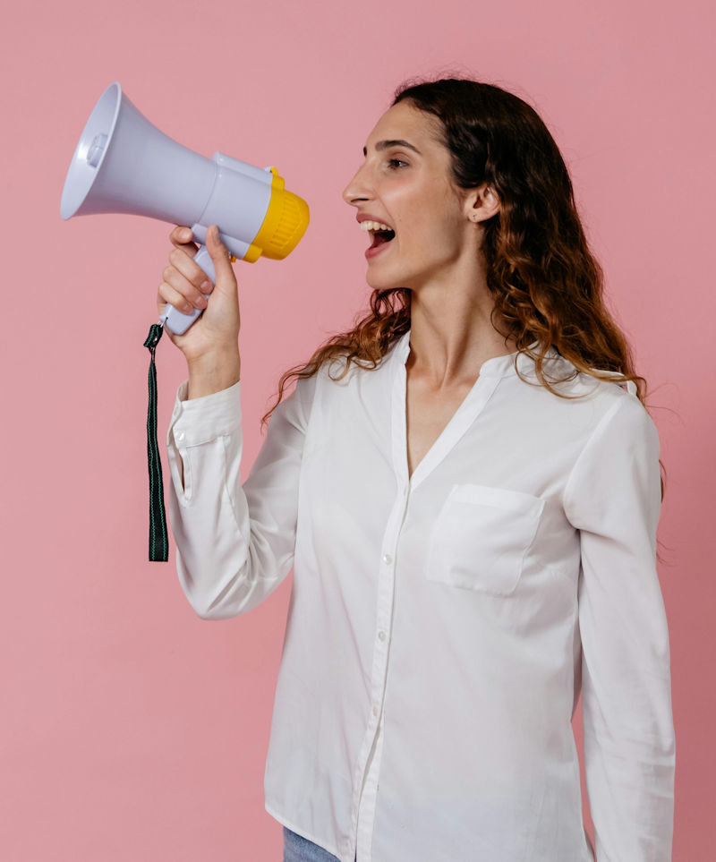 Woman using megaphone to spread good news